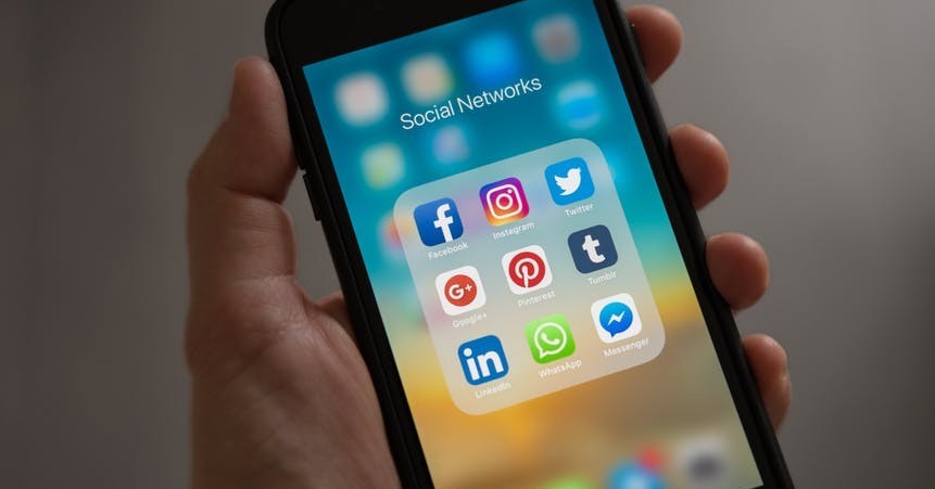 A cell phone with icons of all social media platforms
